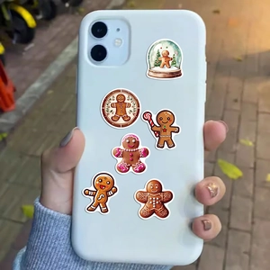 Close-up of gingerbread man Christmas stickers on a mobile phone case for decoration