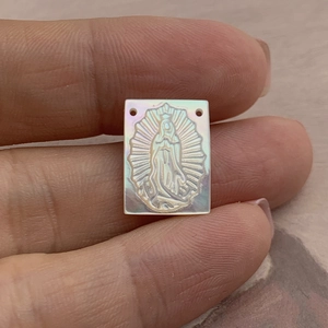 Macro view of iridescent white mother of pearl Guadalupe pendant with two holes