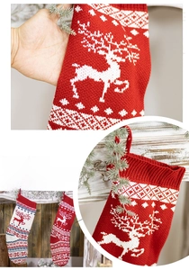 Detail of knitted Christmas stockings with reindeer patterns and hanging loops