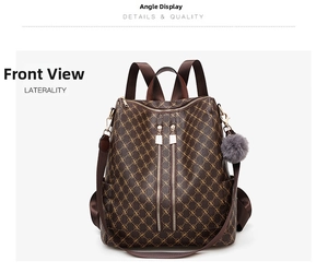 Front detail of brown monogram backpack with decorative zippers and grey pompom charm