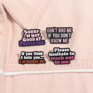 Set of four sarcastic enamel pins with funny English quotes on a pink denim jacket