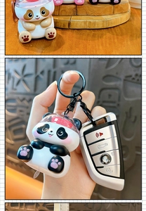 Detailed macro view of a cute glowing panda keychain held next to a car key for scale.