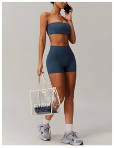 Detail of navy blue high-waist yoga shorts and matching tube top on female model