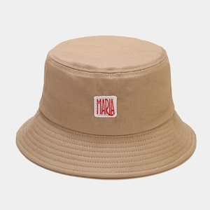 Détail d'un chapeau bob en coton kaki avec patch blanc et broderie Maria rouge