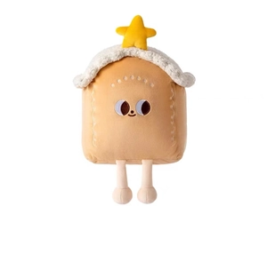 Close-up of plush gingerbread house toy with white snow roof and yellow star