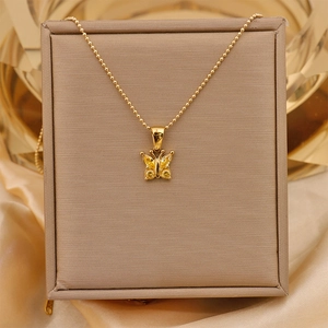 Detail view of the golden 18K titanium steel butterfly pendant with yellow zircon stones