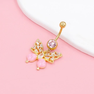 Detail of golden butterfly belly ring with pink gemstones and clear sparkling rhinestones