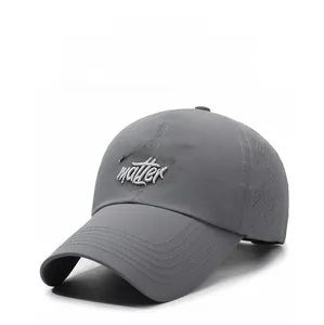 Detail view of laser-perforated side vents and embroidery on gray baseball cap