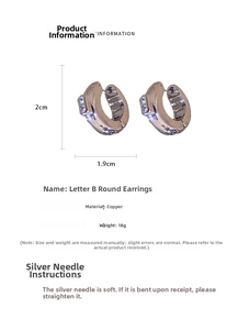 Detailed view of silver hoop earrings with B-letter logo and sparkling crystals