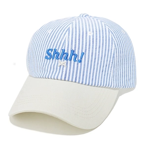 Detail of blue striped baseball cap with Shhh! embroidery and beige visor