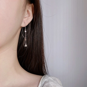 Elegant silver star tassel earrings with long chain pendant for women on model