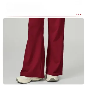 Detailed view of dark red wide-leg sweatpants featuring high-waisted drawstring design