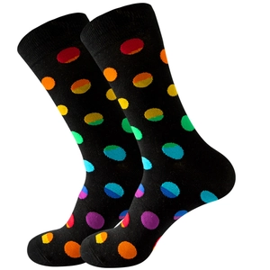 Mid-calf black crew socks with colorful rainbow polka dots on a white background