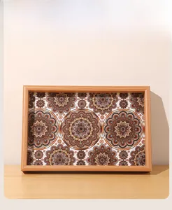 Detail of wooden tray with mandala pattern showing natural grain and intricate artwork
