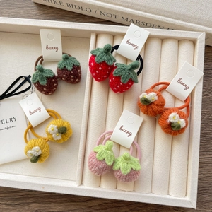 Handmade knitted strawberry and pumpkin hair ties in five vibrant autumn colors