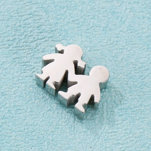 Macro shot of polished stainless steel couple figurines for DIY jewelry on blue surface