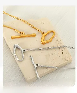 Detail of snake chain and box chain necklace with an irregular OT toggle clasp
