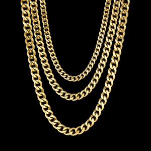 Macro shot of three-layered golden Cuban link chains against a sleek black background
