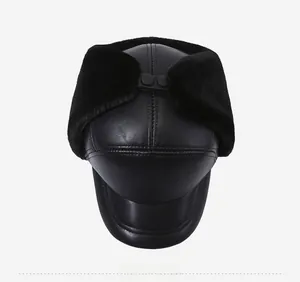 Top view of men's winter thermal leather hat with warm black faux fur lining and snap button