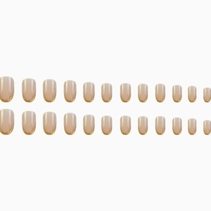 French gradient press-on nails in nude pink and white with elegant gold curved tips