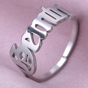 Macro shot of silver stainless steel adjustable ring with Seventeen letter cutout