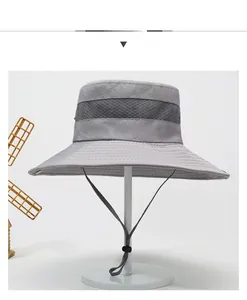 Detail of wide-brimmed sun hat with breathable mesh and adjustable chin strap