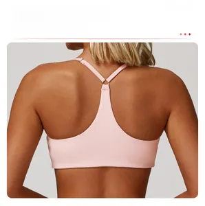Detail of pink Y-back sports bra with elastic fabric and metal ring connector design