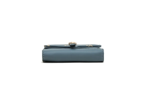 Detail of grey-blue leather wallet showing gold leaf print and metal magnetic clasp