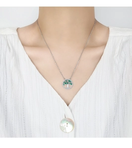 Detail of tree of life necklace featuring green zircon stones on silver cable chain