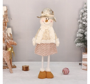 Detail of a handmade plush Christmas snowman figurine with gold hat and plaid skirt decor