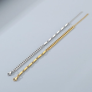 Detail of silver and gold titanium steel Cuban chain bracelets with toggle clasp design