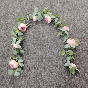 Macro detail of artificial pink rose and eucalyptus garland for wedding arch decor