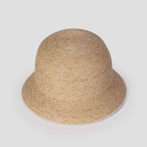 Detailed view of natural raffia weave on the elegant round crown of this sun hat