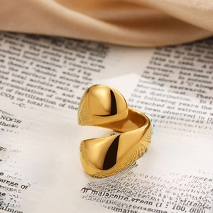 Close-up of a polished 18K gold-plated teardrop ring with a minimalist sculptural design