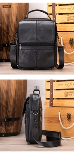 Detail of black lychee grain leather crossbody bag with top handle and multiple zip pockets