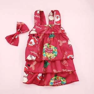 Detail of red floral Christmas puppy dress set with matching bow and tiered ruffle skirt