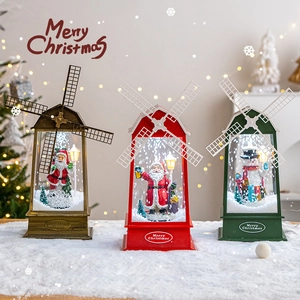 Three Christmas lantern decorations with snow and glowing LED in red, green and bronze colors