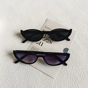 Retro cat-eye sunglasses with black and purple gradient lenses on a minimalist background