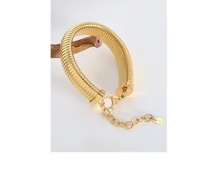 Detail of 18K gold plated thick snake chain bracelet with K18 tag and lobster clasp