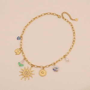 Golden stainless steel necklace featuring sun clover flower beads and pearls on beige background