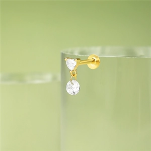 Macro shot of 925 silver golden labret stud with heart and round cubic zirconia charms