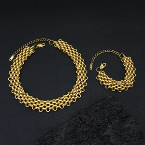 Detailed close-up of 18K gold plated mesh chain necklace and bracelet with lobster clasp