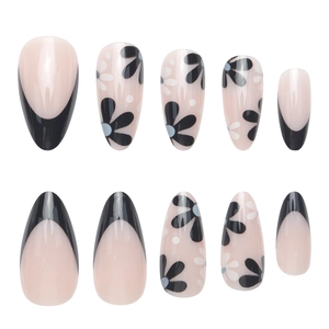 Almond-shaped press-on nails with black French tips and daisy floral patterns
