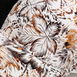 Graffiti leaf baseball cap with white fabric texture and artistic brown foliage patterns