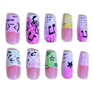 Detailed view of long coffin nails with Y2K pink gradient and star music patterns