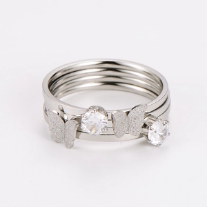 Detail of multi-layer stainless steel ring featuring frosted butterflies and zircon stones