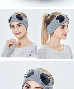 Detail of grey knitted ear warmer headband with integrated black goggles for urban style
