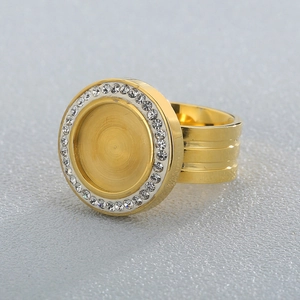 Men's gold plated stainless steel signet ring with inlaid diamond disc on gray background