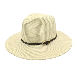 Detailed macro view of beige woven sun hat with leather band and gold buckle detail