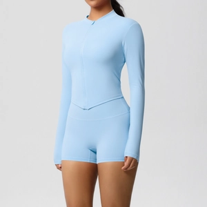 Detail of sky blue sports set featuring V-shaped hem jacket and high waist shorts